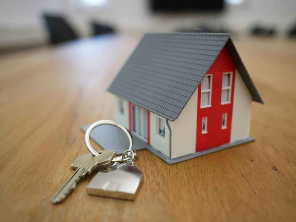 Miniature house with key on table